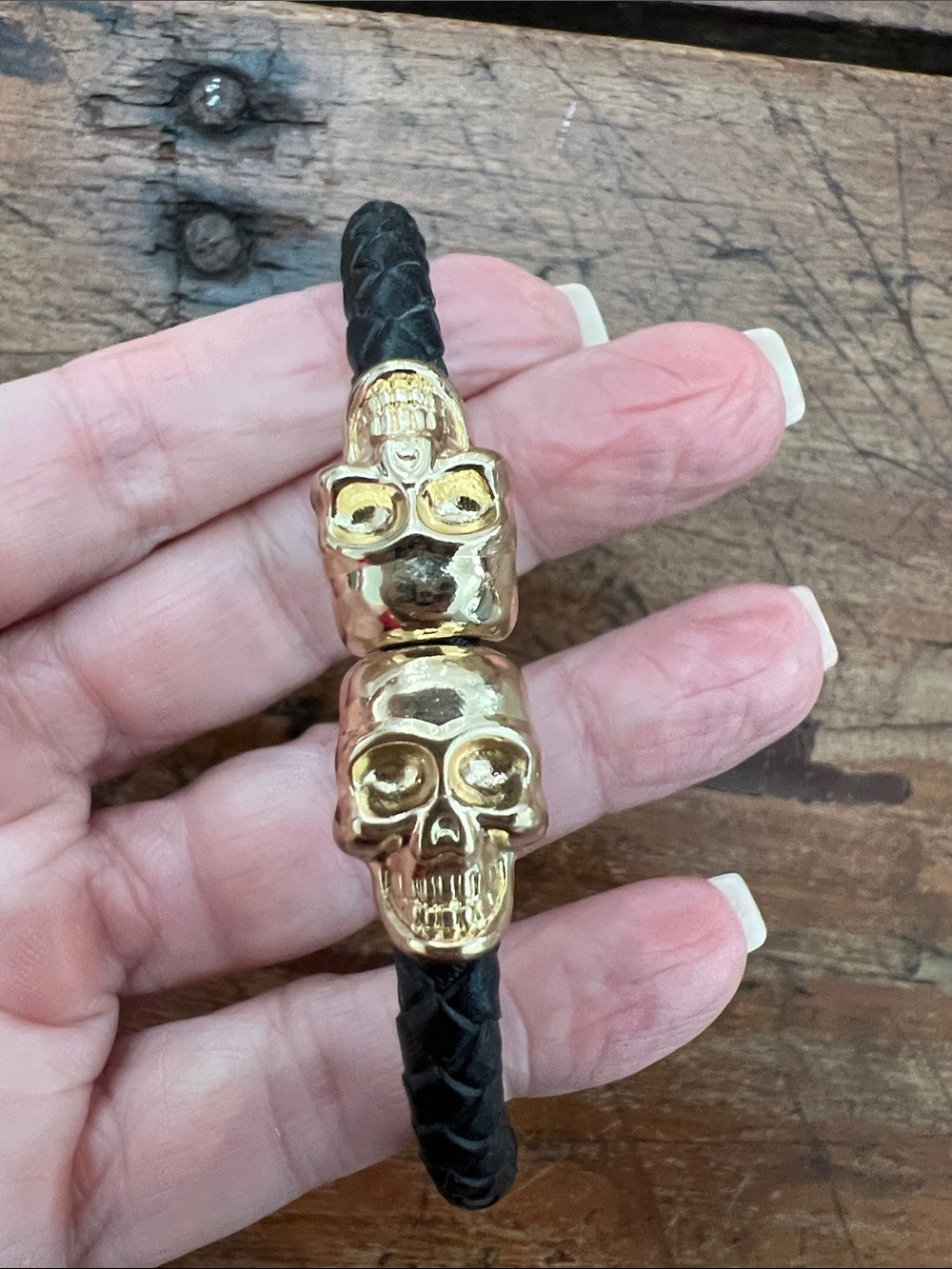 NorthSkull Gold Twin Skull Bracelet Braided Black Nappa Leather Unisex. 8.5”.